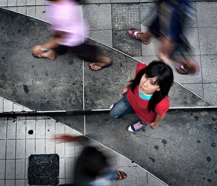 Looking down at a woman on the sidewalk in Bangkok. Tips For Travel Photography etiquette in Thailand