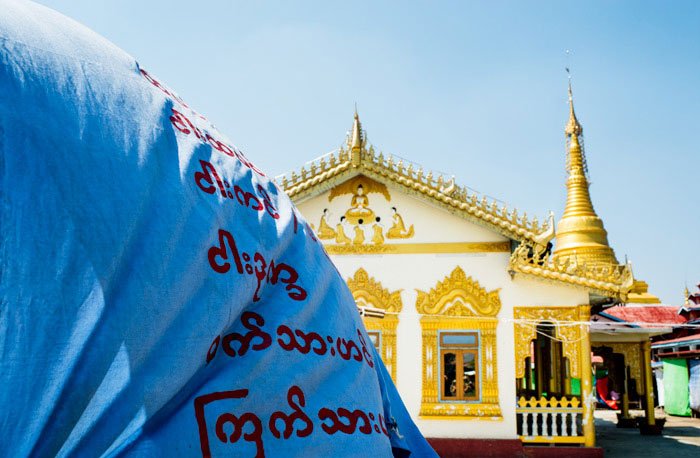 Temple and flag on Inle lake © Kevin Landwer-Johan