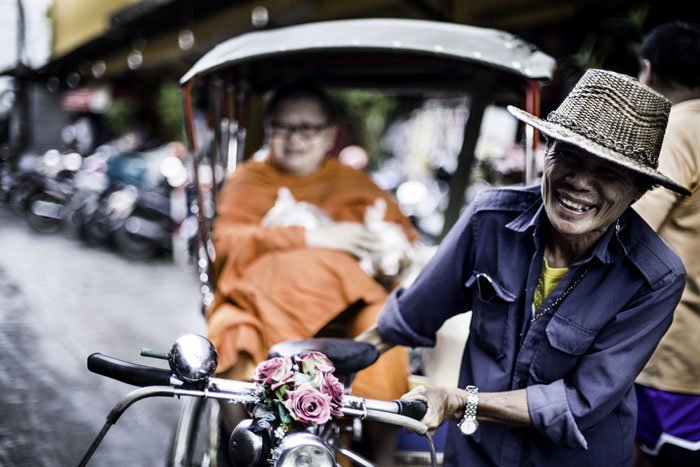 Buddhist monk in a tricycle taxi