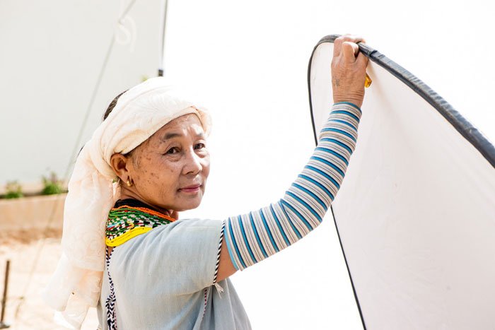 Karen Assistant Holding a Reflector