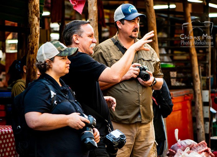 Kevin Landwer-Johan teaching a couple during a Chiang Mai Photo Workshop. Tips For Travel Photography etiquette in Thailand