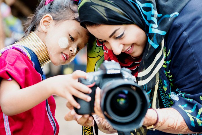Kayan girl and Arab woman with a DSLR camera during a Chiang Mai Photo Workshop