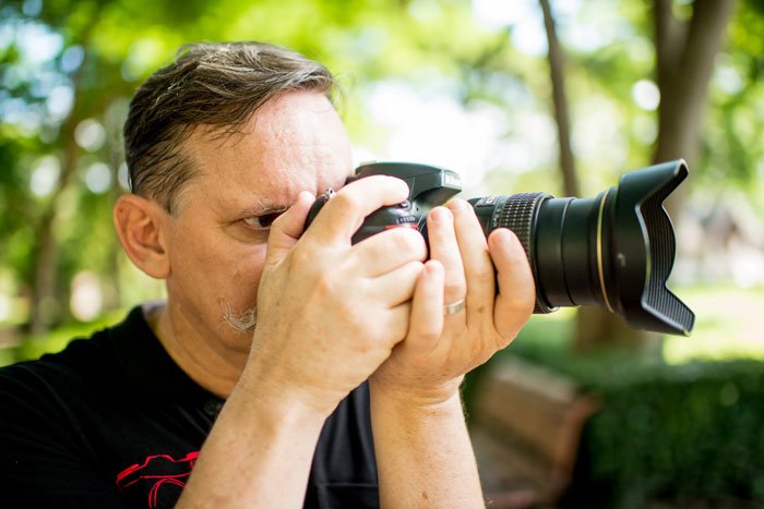 Man using a DSLR camera, Improve Your Photography