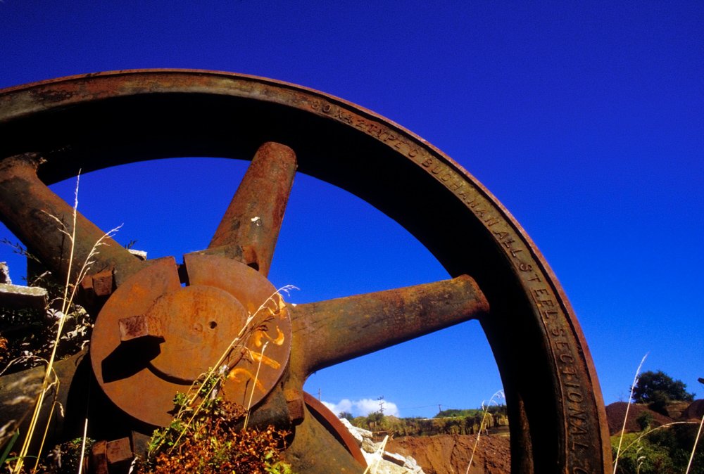 Large rusty iron wheel.