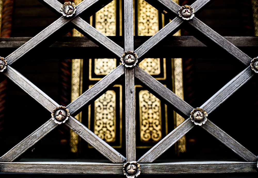 Detail on an old teak building in Chiang Mai, Thailand. camera settings