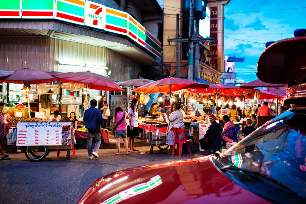 How To Compose the Best Photos – Fill The Frame. A 'Song Tao' taxi passes some of the many stalls selling food which are set up each evening at the Wararot Market in Chiang Mai, Thailand, Asia.  © Kevin Landwer-Johan