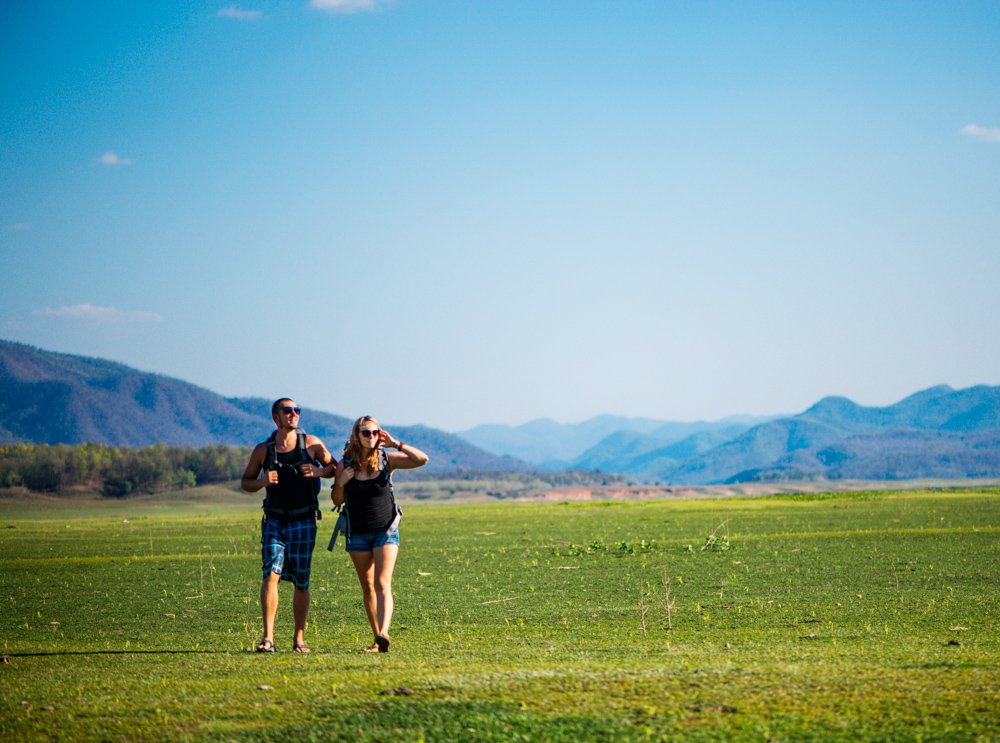 How To Compose the Best Photos – Fill The Frame. Young couple walking together in an empty field.  © Kevin Landwer-Johan