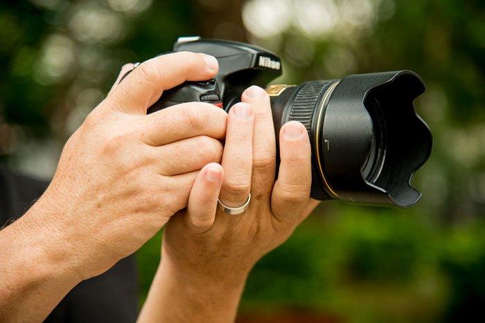 Holding a DSLR camera The Best Idea to Make You a More Inspired Photographer