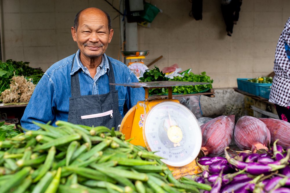 Happy Vegetable Vendor at Muang Mai Market in Chiang Mai, Thailand