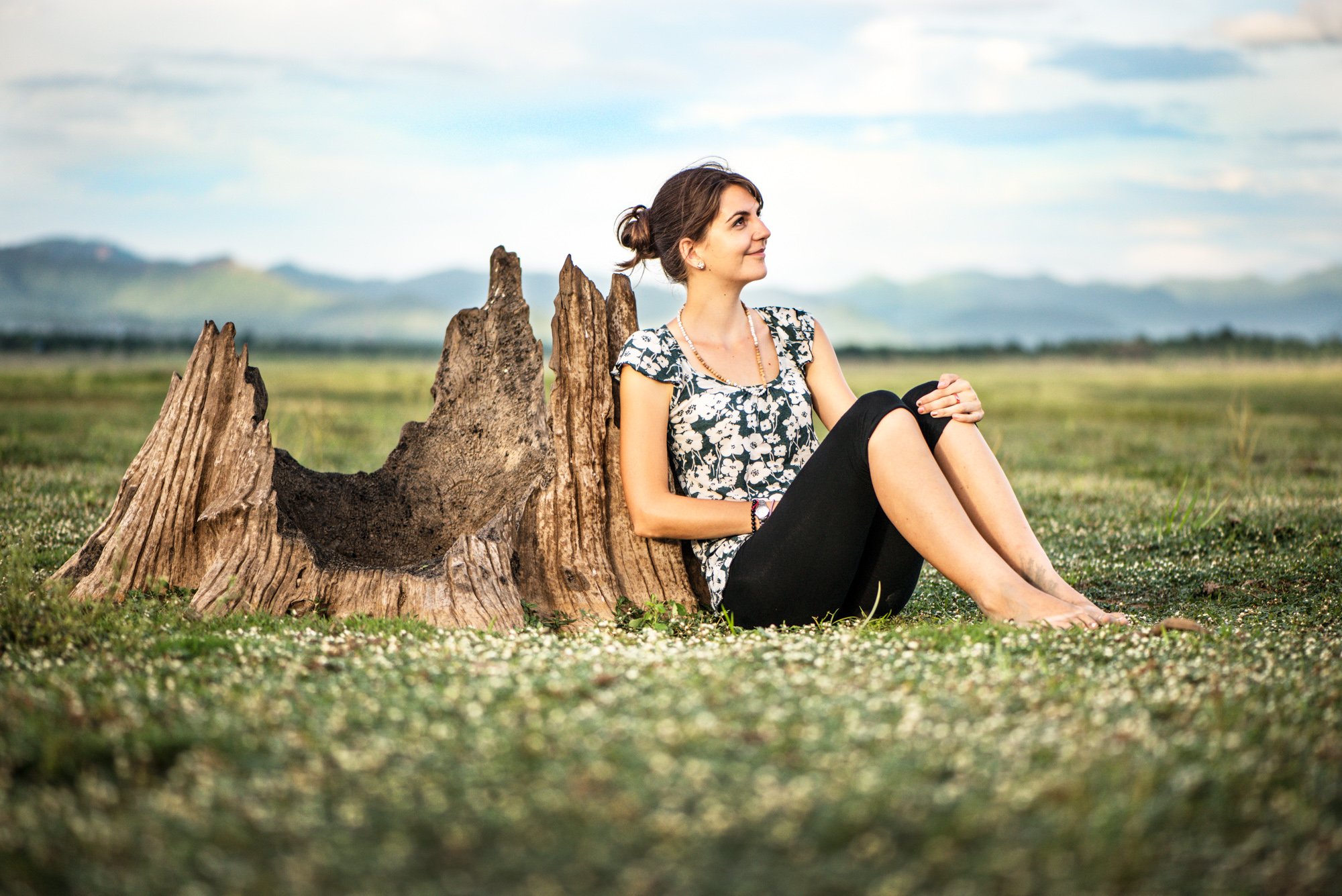 young woman sitting in the field