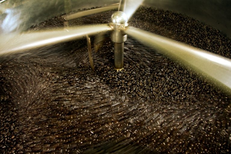 Coffee being cooled in the cooling car of a small batch roasting oven