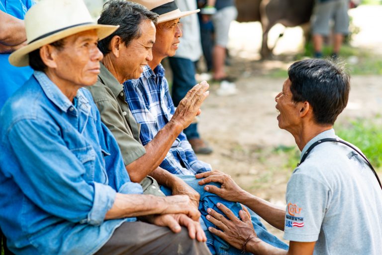 Farmers talking at a Thai cattle market.