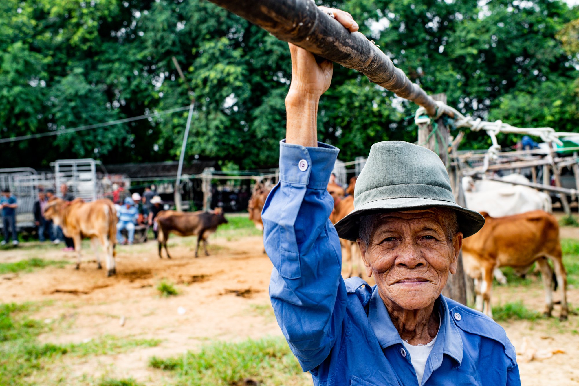 A farmer poses for a photo at the cattle market. © Kevin Landwer-Johan
