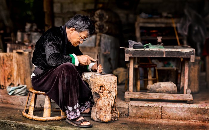 Hmong blacksmith blurred background portaits