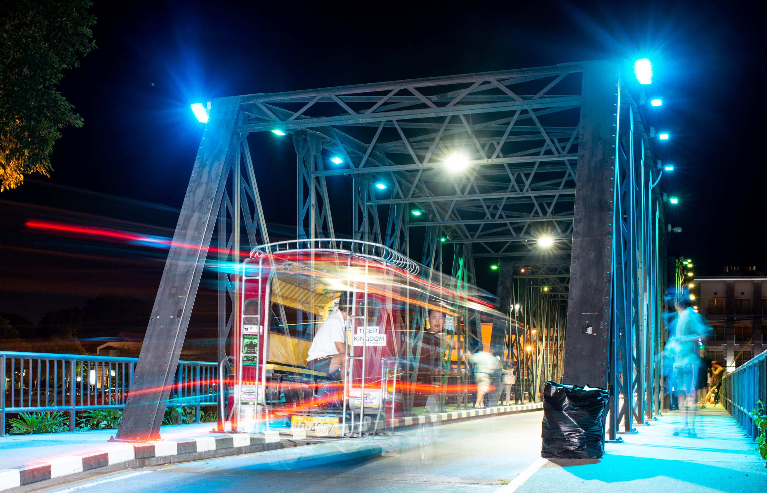 Vehicle crossing a bridge in Chiang Mai, Thailand, at night - for Photography Mentorship Program