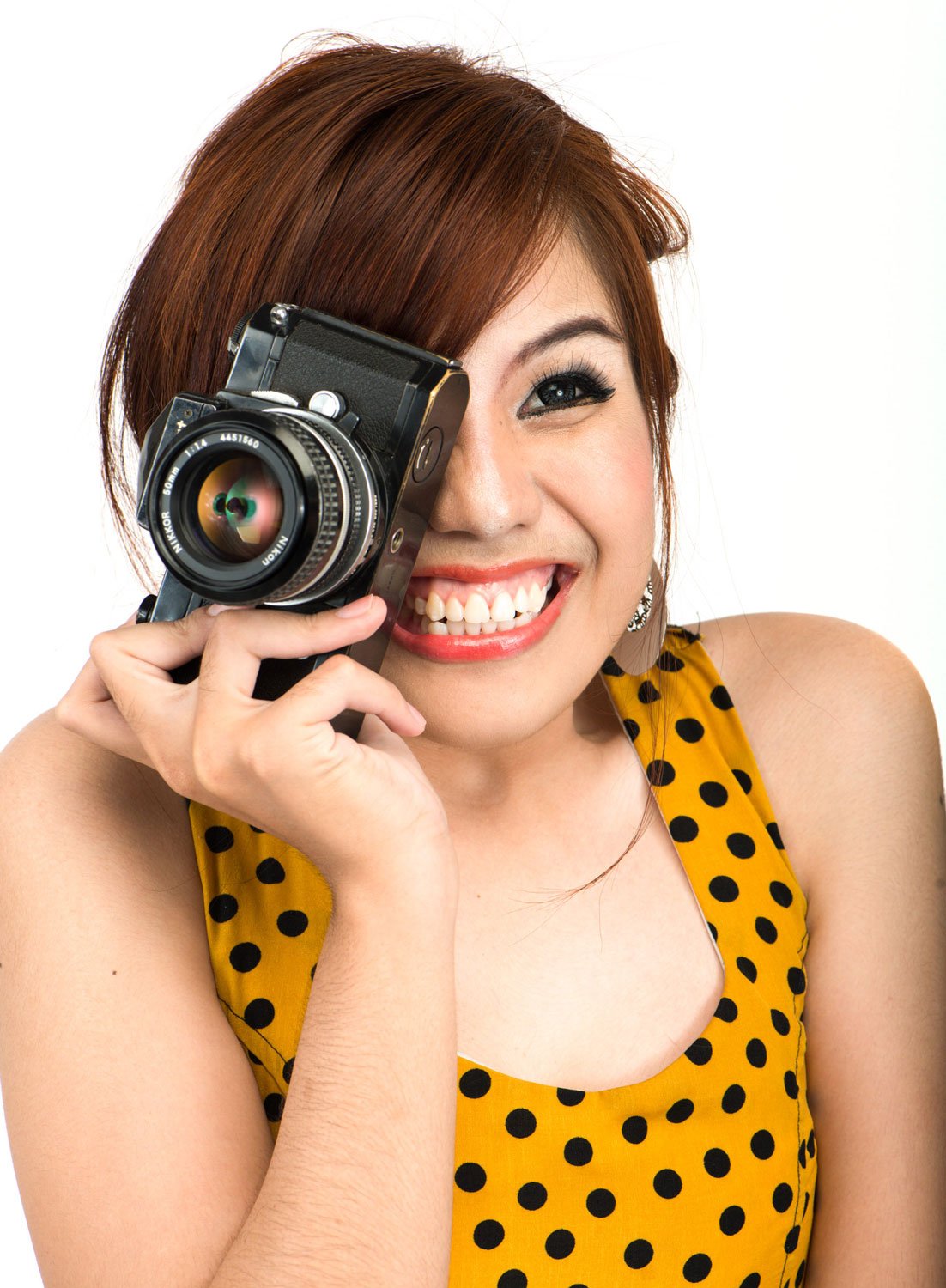 Thai woman choosing the best camera, studio photo