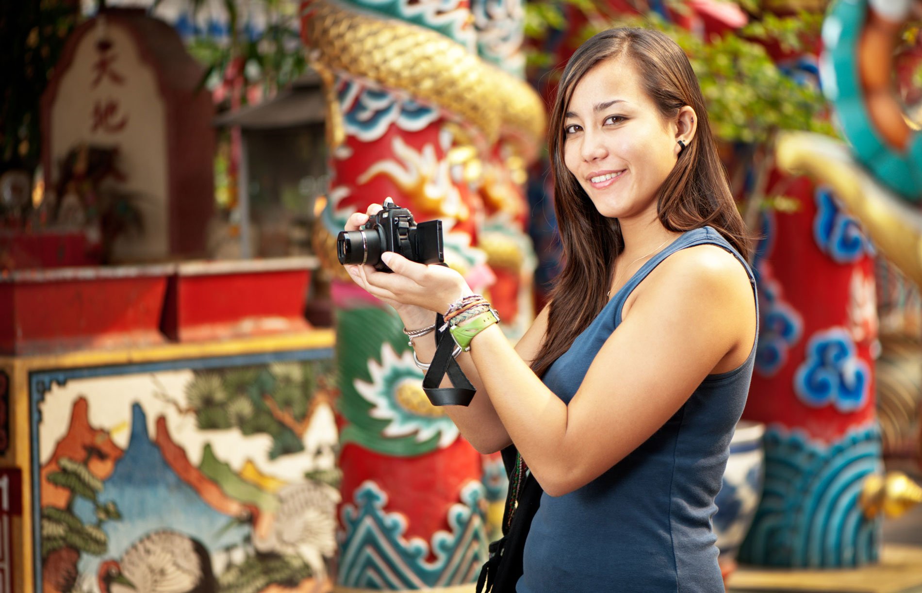 Asian woman with a camera for how to choose a camera