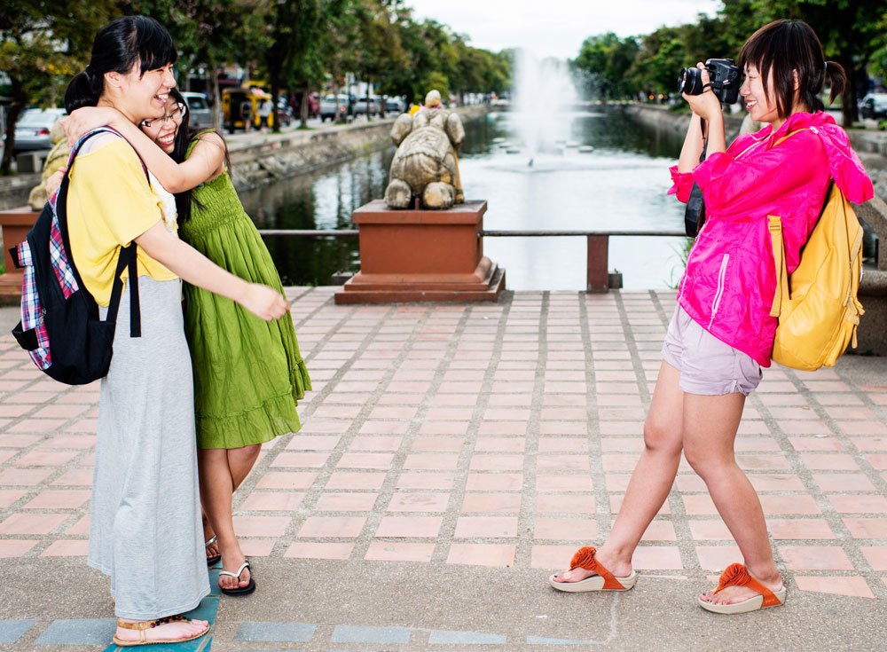 Asian women taking a photo with a DSLR camera