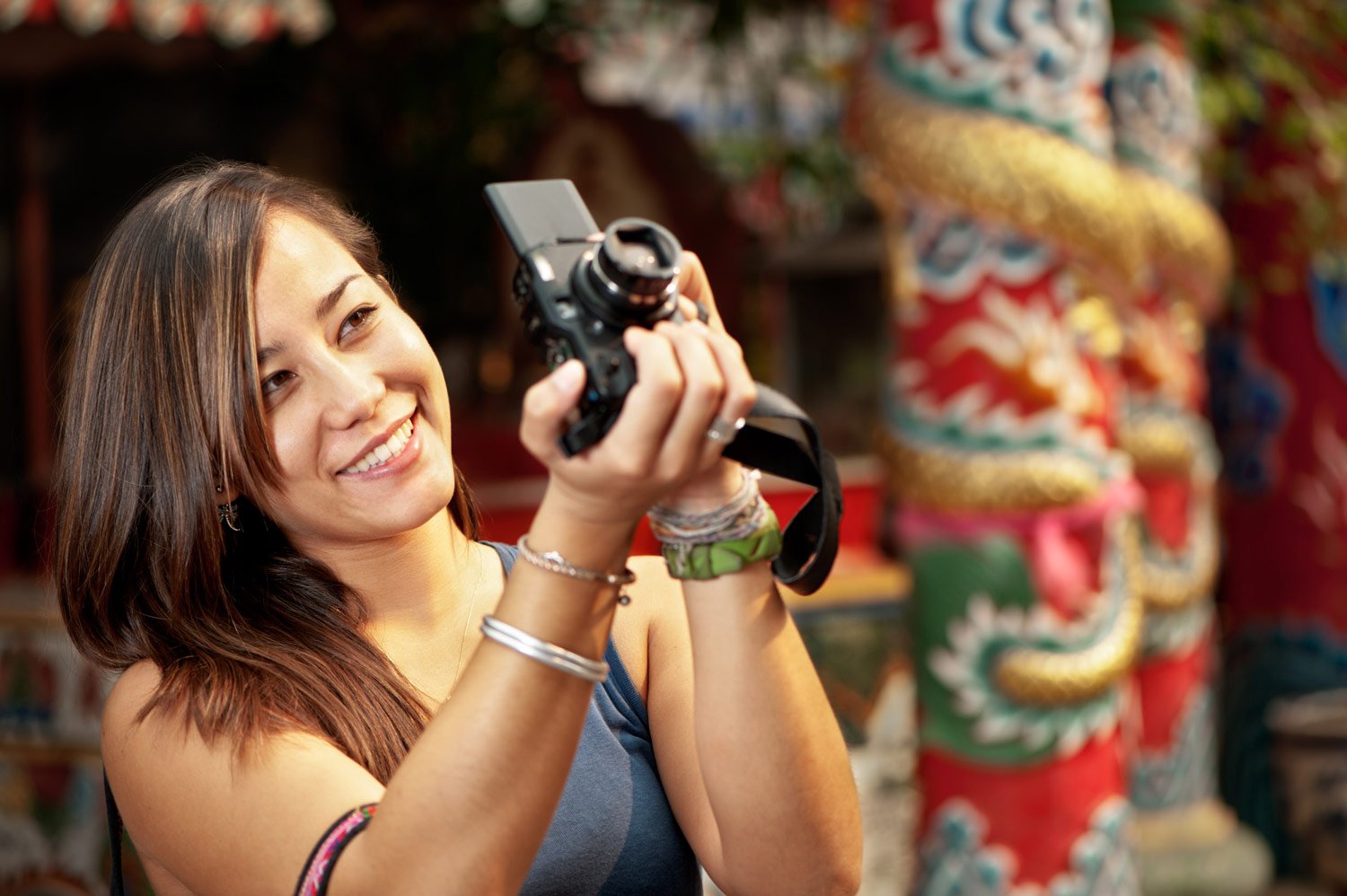 happy woman with a new camera taking photo © Kevin Landwer-Johan