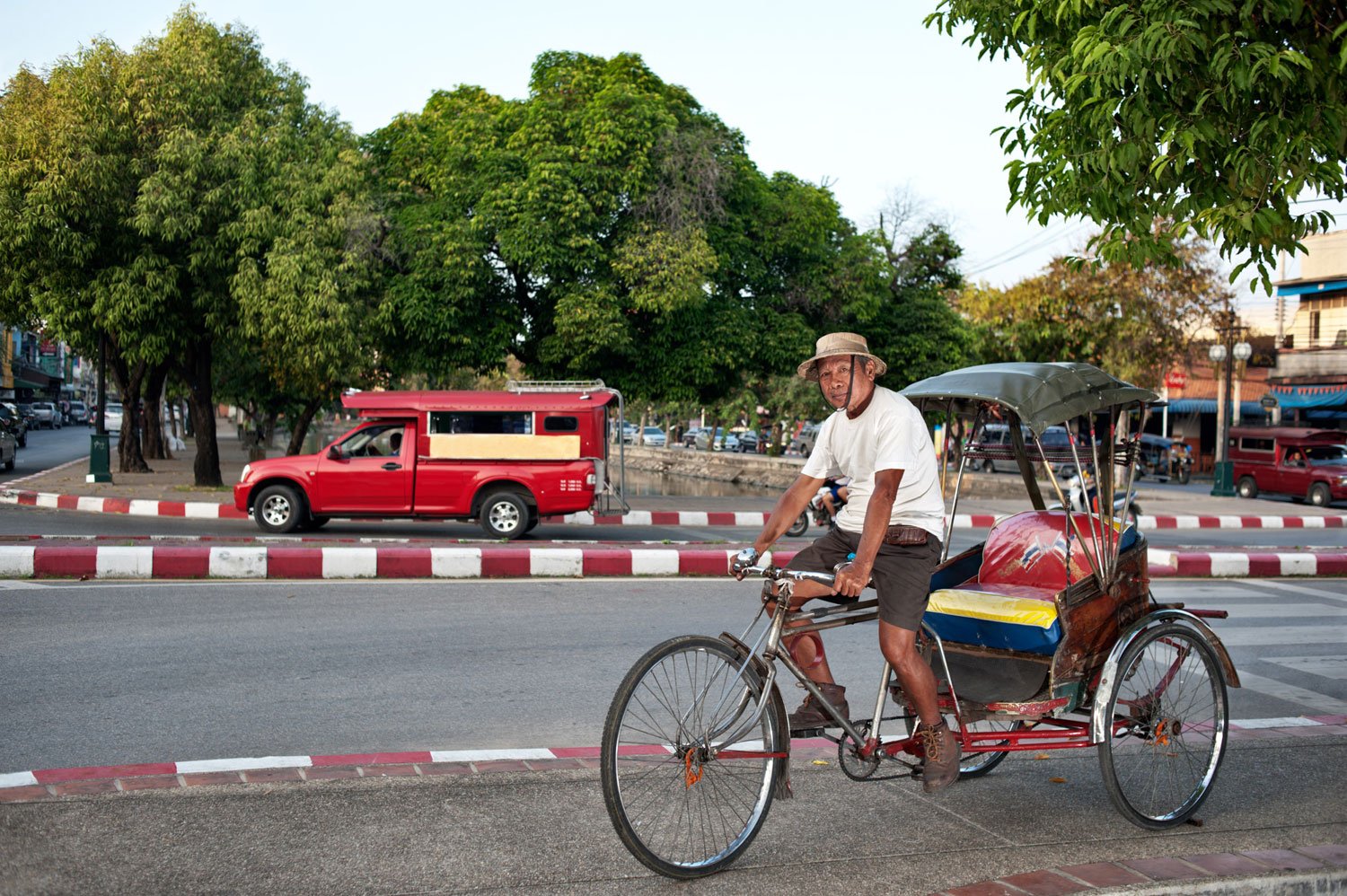 environmental portrait of a samlor rider in Chiang Mai, Thailand, © Kevin Landwer-Johan