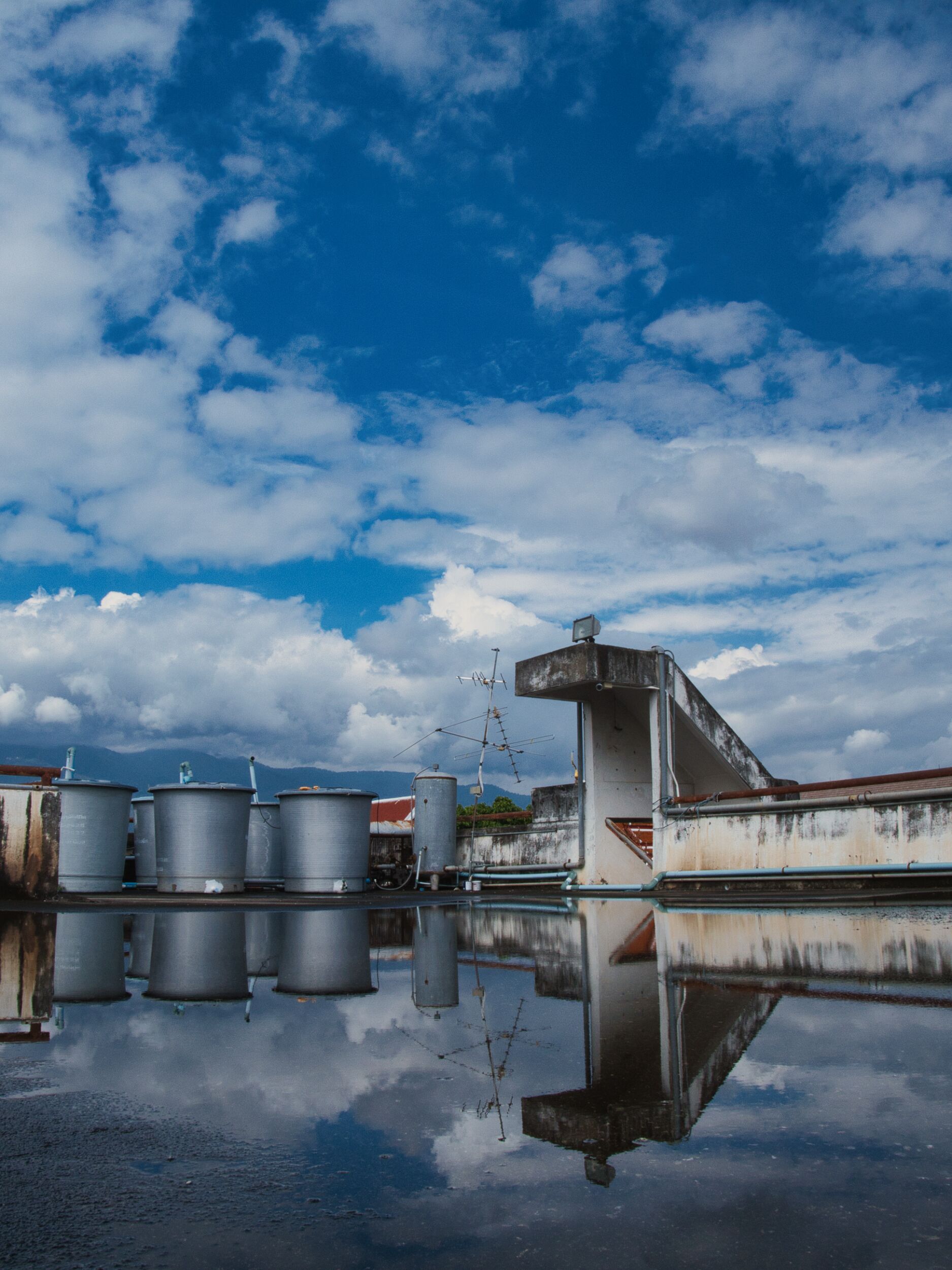 Roof top scene with water tanks and a cloudy sky for Luminar Neo review