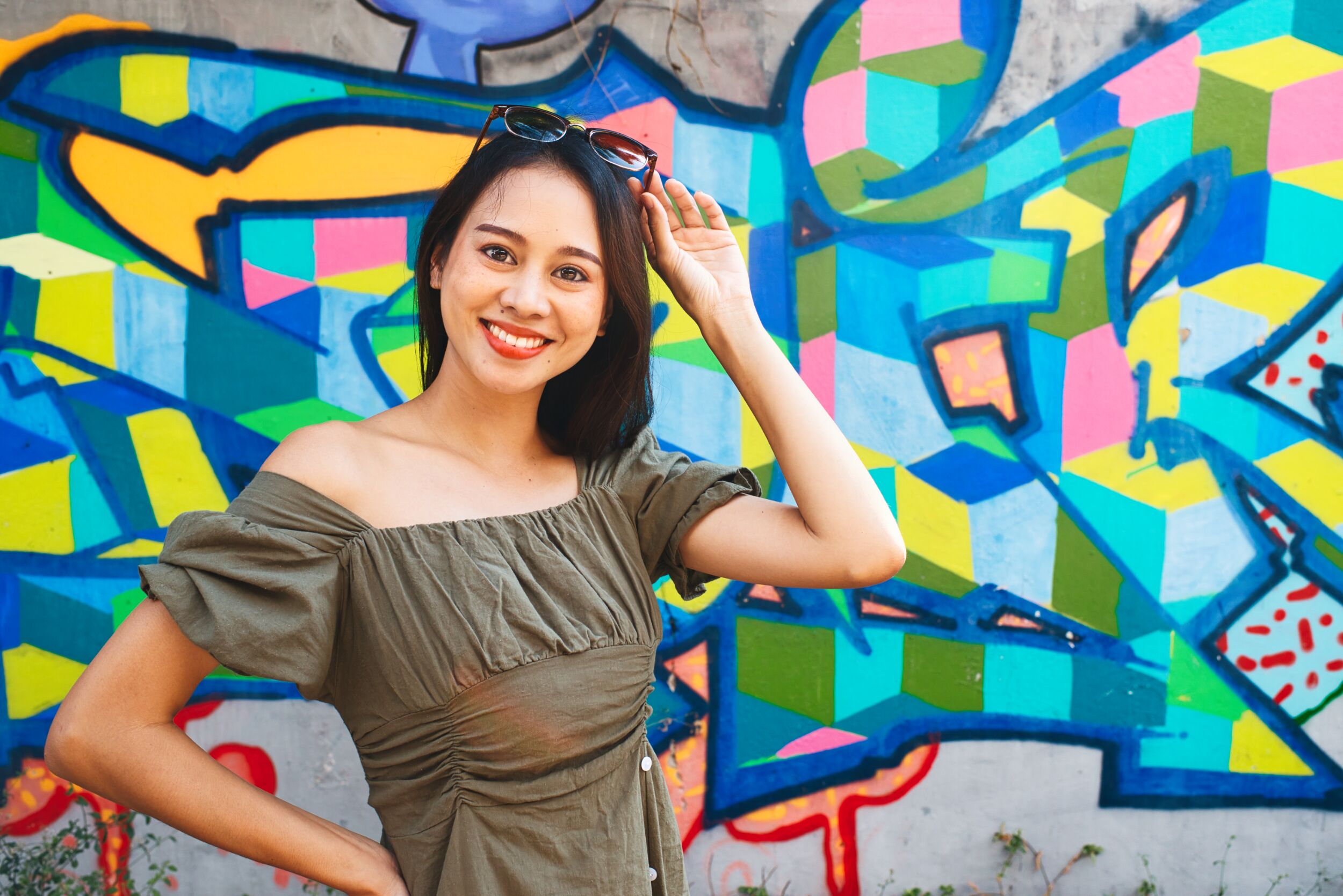 woman posing in front of a street art mural